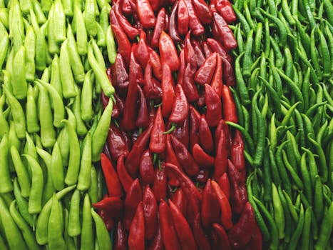 A colorful arrangement of fresh green and red chili peppers showcasing natural freshness and spice.